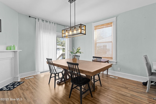 dining room featuring hardwood / wood-style flooring and a chandelier