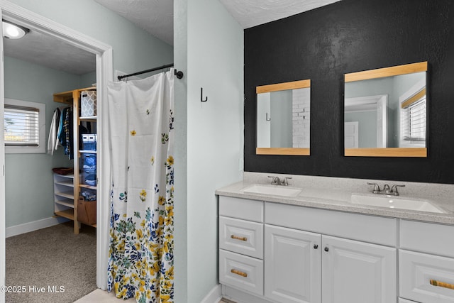 bathroom featuring vanity and curtained shower