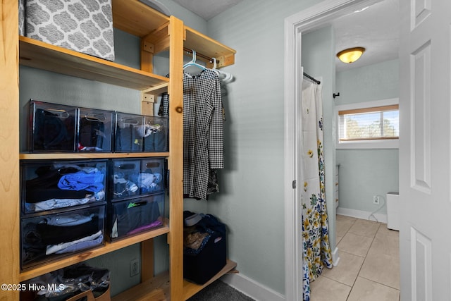 spacious closet with light tile patterned floors