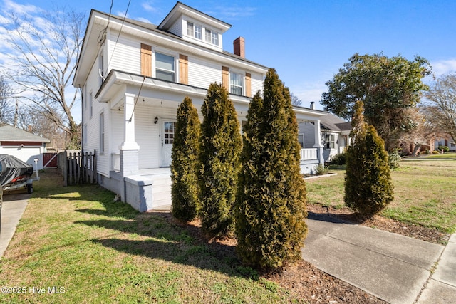 view of front facade with covered porch and a front yard