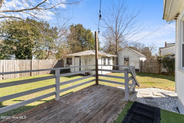 wooden deck with a storage shed and a lawn