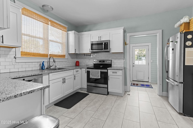 kitchen featuring white cabinetry, stainless steel appliances, and sink