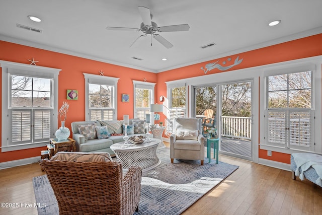 living room with visible vents and hardwood / wood-style flooring