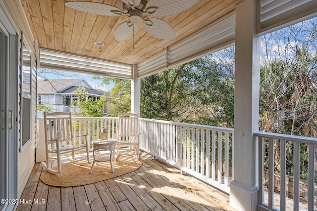 wooden deck featuring a ceiling fan