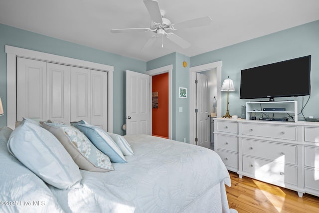 bedroom with a closet, ceiling fan, and light wood finished floors