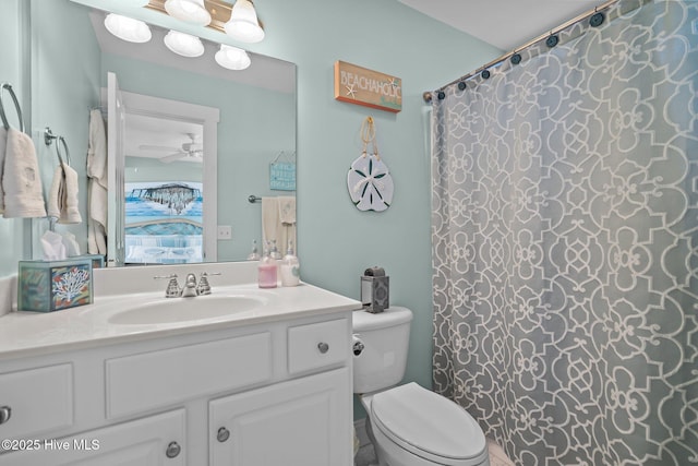 ensuite bathroom with ceiling fan, connected bathroom, toilet, a shower with shower curtain, and vanity