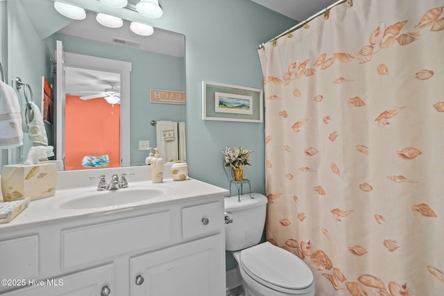 bathroom featuring toilet, ceiling fan, visible vents, and vanity