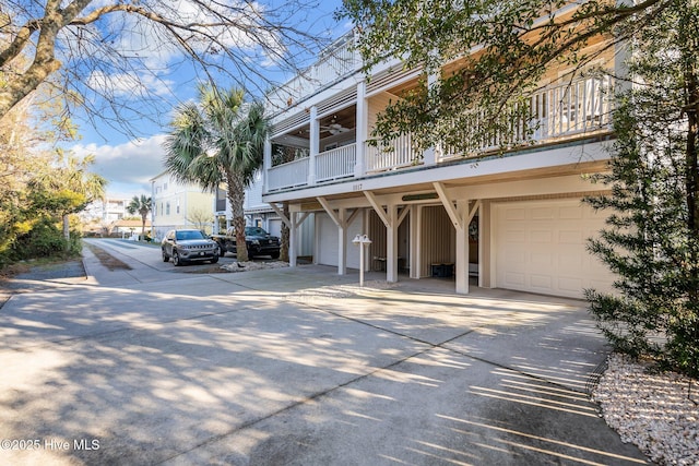 view of property with a garage and concrete driveway