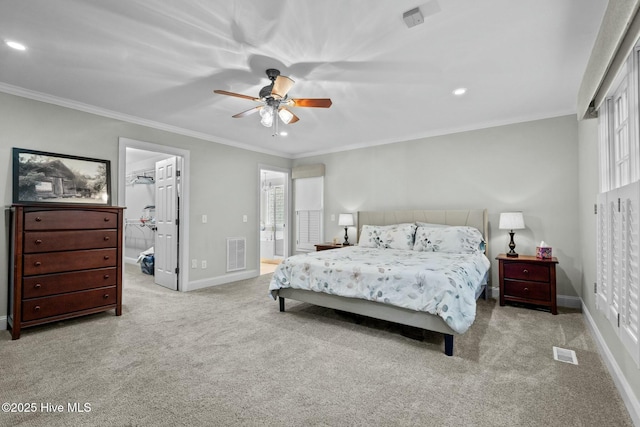 bedroom featuring light carpet, a spacious closet, visible vents, and baseboards