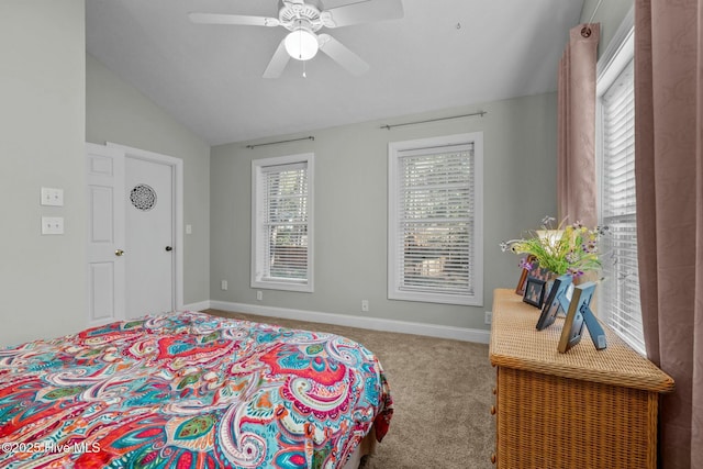 carpeted bedroom with lofted ceiling, multiple windows, baseboards, and a ceiling fan