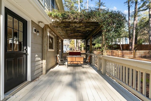 wooden terrace featuring outdoor dining area and fence