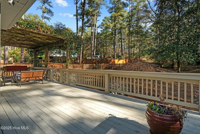 wooden terrace with fence and a pergola