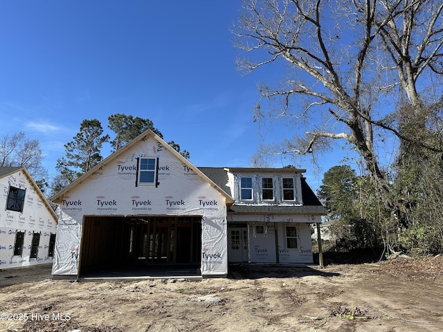 unfinished property featuring an attached garage