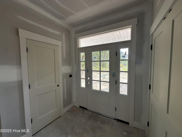 doorway to outside featuring unfinished concrete floors