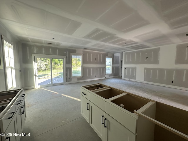 kitchen with baseboards and white cabinets