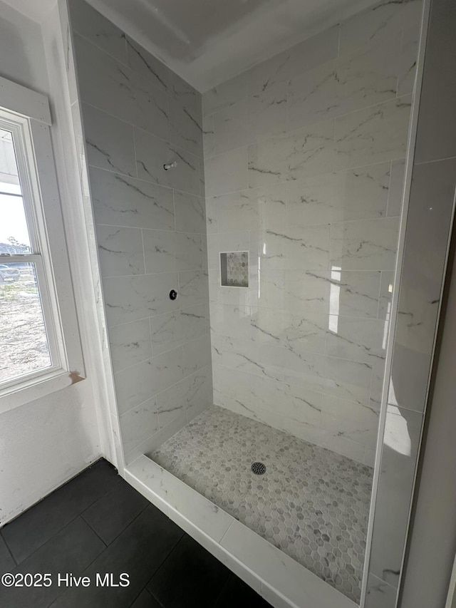 full bathroom with a shower stall and tile patterned flooring