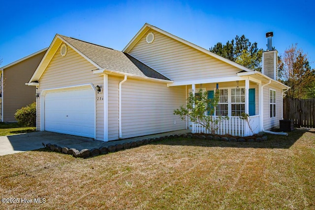 view of front facade with concrete driveway, a chimney, fence, an attached garage, and a front lawn
