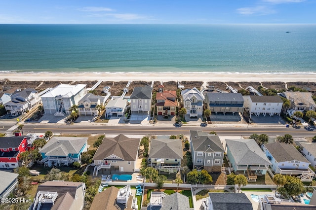 bird's eye view featuring a water view, a view of the beach, and a residential view