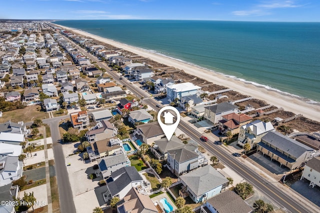 birds eye view of property with a beach view and a water view