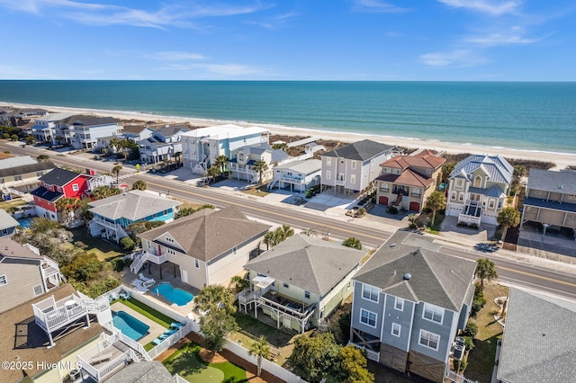 drone / aerial view with a water view, a residential view, and a view of the beach