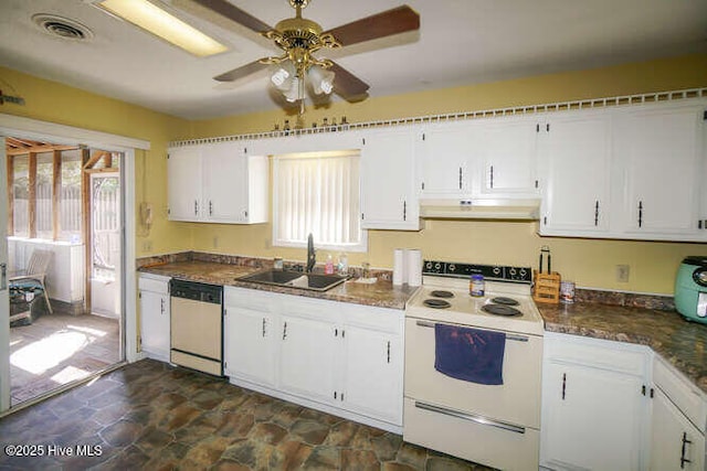 416 Trott St, Oak Island, NC 28465 - kitchen with white appliances, under cabinet range hood, white cabinetry, ceiling fan, and dark stone finish flooring