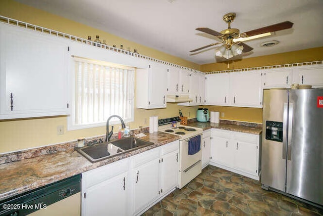 416 Trott St, Oak Island, NC 28465 - kitchen featuring stainless steel appliances, a ceiling fan, white cabinetry, dark stone finish flooring, and under cabinet range hood