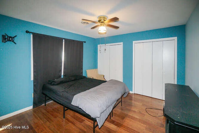 416 Trott St, Oak Island, NC 28465 - bedroom with two closets, wood finished floors, and a ceiling fan