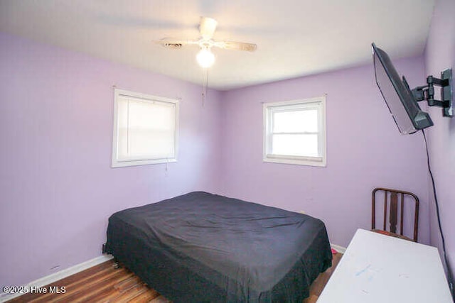 416 Trott St, Oak Island, NC 28465 - bedroom featuring wood finished floors and a ceiling fan