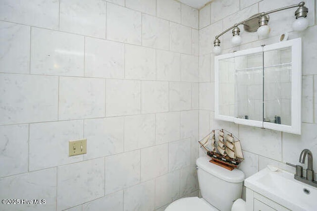 416 Trott St, Oak Island, NC 28465 - bathroom with vanity and tile walls