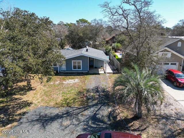 416 Trott St, Oak Island, NC 28465 - view of front of property with driveway, board and batten siding, a porch, and a garage