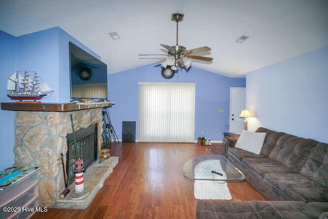 416 Trott St, Oak Island, NC 28465 - living room featuring ceiling fan, vaulted ceiling, wood finished floors, and a stone fireplace