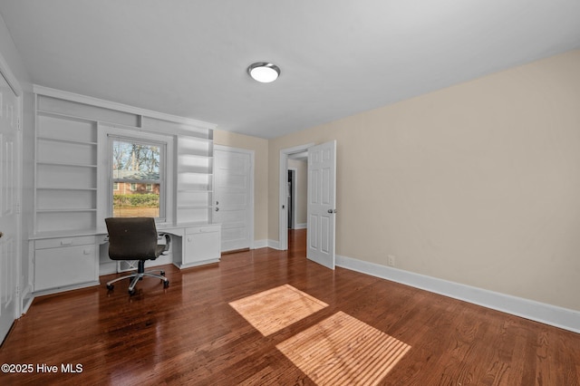 office space with built in features and wood-type flooring