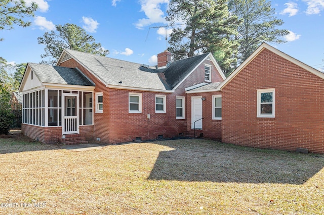 back of property featuring a sunroom and a lawn