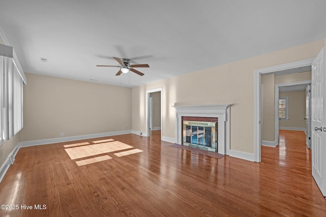 unfurnished living room with ceiling fan and hardwood / wood-style floors