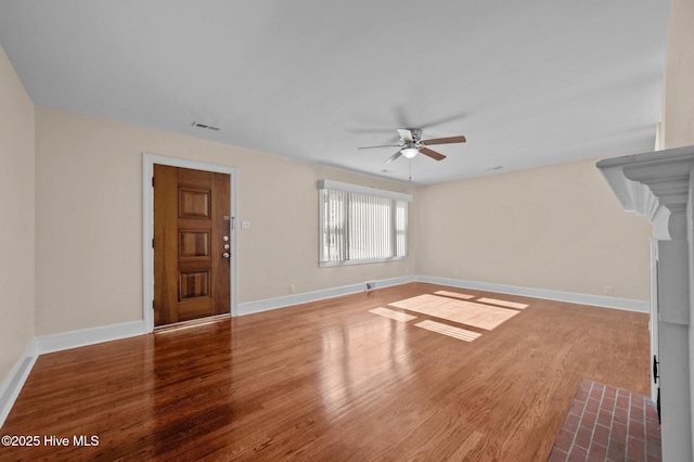 unfurnished living room with hardwood / wood-style floors and ceiling fan