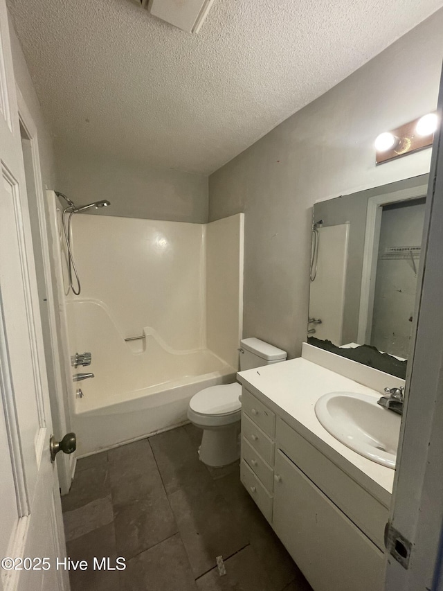 full bathroom featuring toilet, bathing tub / shower combination, vanity, and a textured ceiling