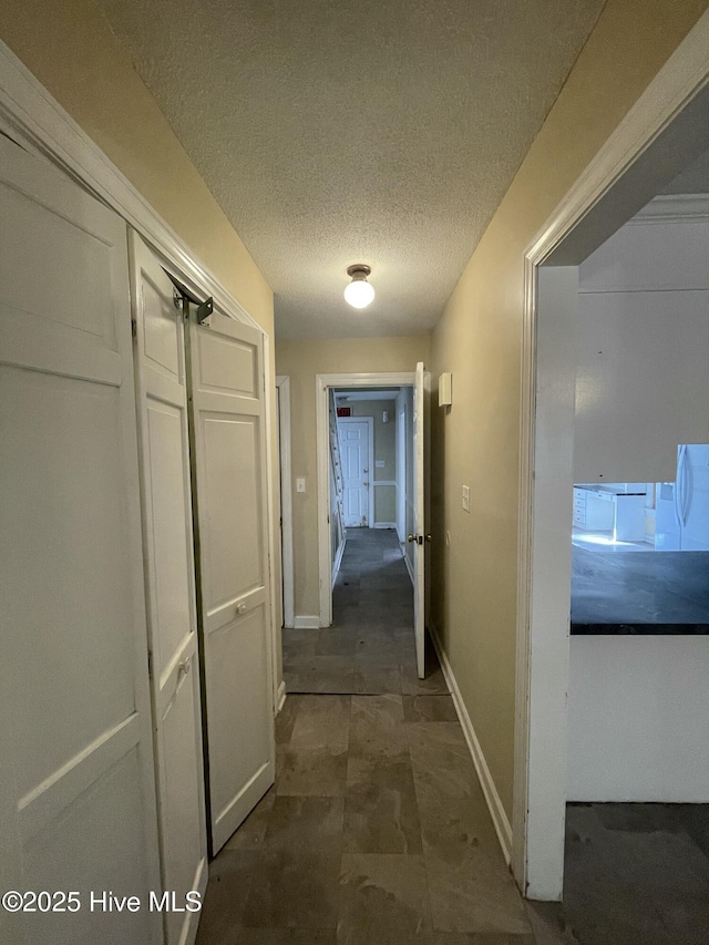 hallway with a textured ceiling