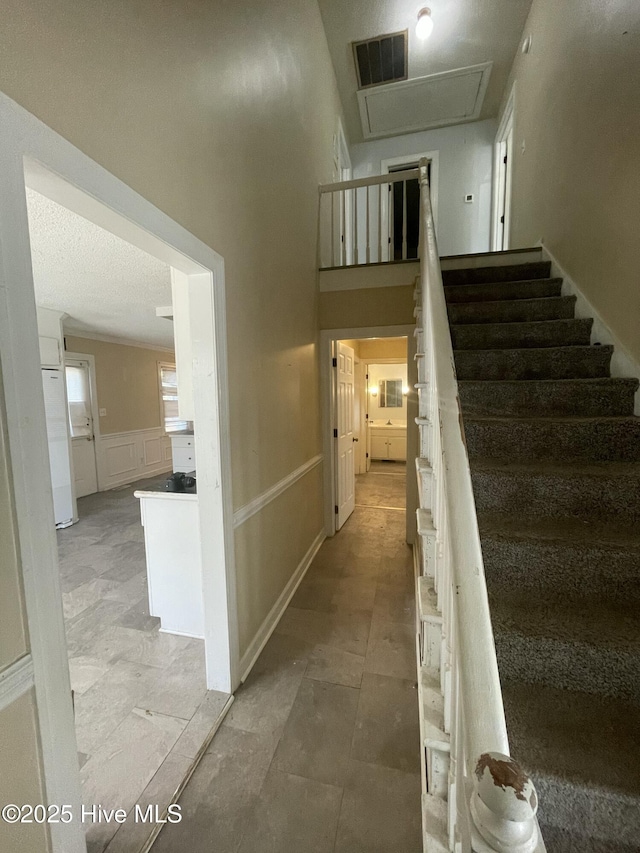 staircase featuring a towering ceiling