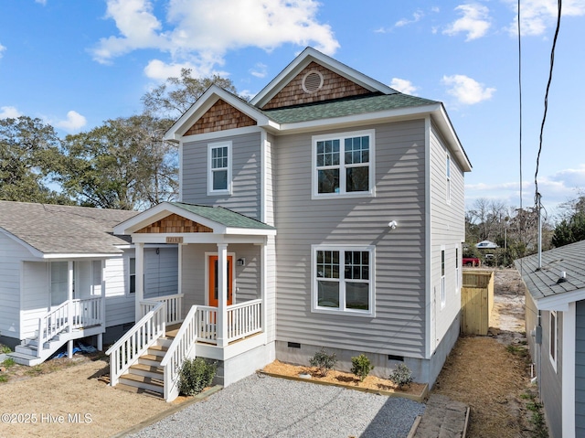 view of front facade featuring roof with shingles and crawl space