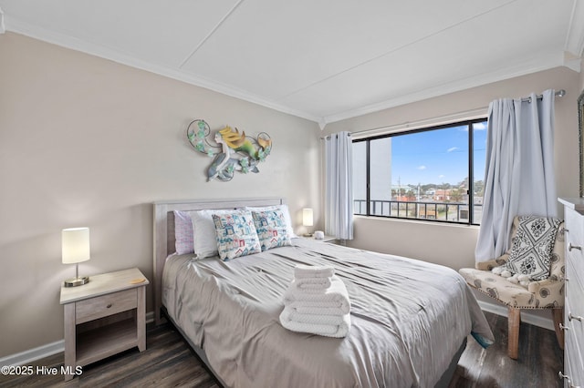 bedroom with baseboards, dark wood-style flooring, and crown molding