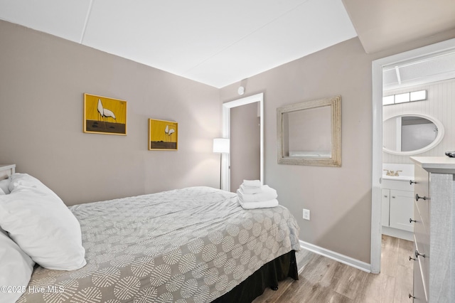 bedroom featuring baseboards and light wood-style floors