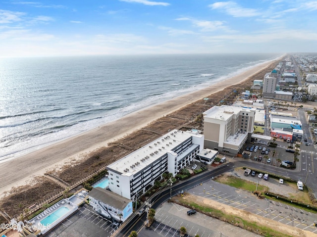 drone / aerial view with a water view and a beach view