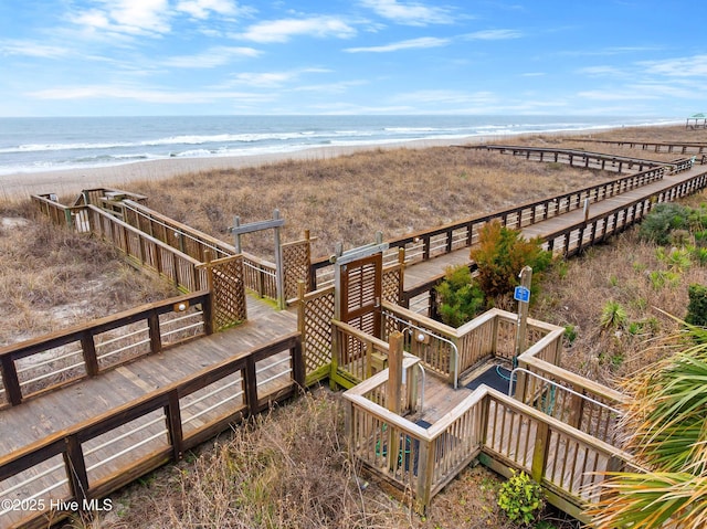 birds eye view of property featuring a water view and a beach view