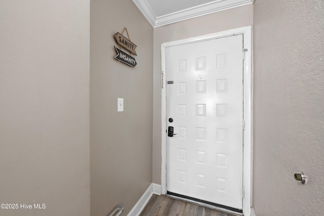 doorway to outside featuring baseboards, ornamental molding, and dark wood finished floors