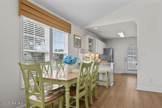2011 Fisher St, Morehead City, NC 28557 - dining area with light wood finished floors and vaulted ceiling