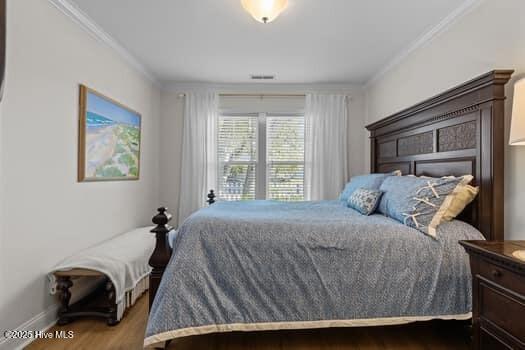 2011 Fisher St, Morehead City, NC 28557 - bedroom featuring ornamental molding and wood finished floors