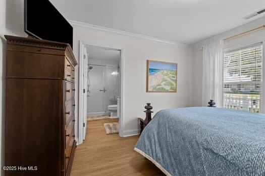 2011 Fisher St, Morehead City, NC 28557 - bedroom featuring light wood-style flooring, ornamental molding, and ensuite bath