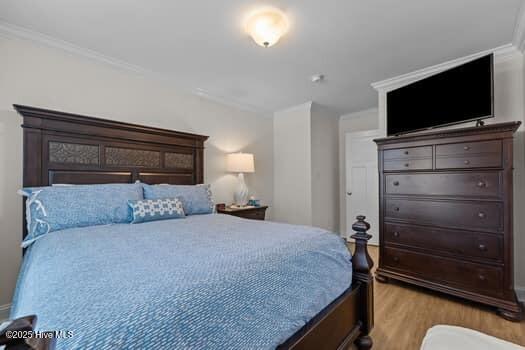2011 Fisher St, Morehead City, NC 28557 - bedroom with light wood-type flooring and crown molding
