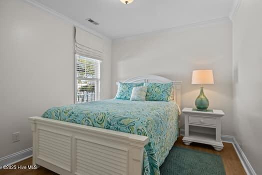 2011 Fisher St, Morehead City, NC 28557 - bedroom featuring wood finished floors and ornamental molding