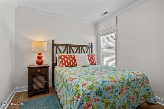 2011 Fisher St, Morehead City, NC 28557 - bedroom with crown molding and wood finished floors